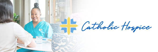 Two people sitting at a table related to Catholic Hospice - Netsmart's RCM services support revenue cycle management efficiency through cash acceleration