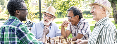 4 men sitting around talking - Netsmart senior living EHR software