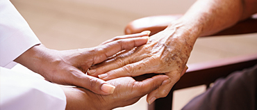 Blog Senior Living Nurse holding Elderly Patient's hand