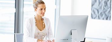 Managed Services Woma working at a Desktop to manage a Post Acute Healthcare Clinic